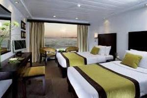 卢克索Premium Nile Cruise Luxor To Aswan 4Nights started from luxor 3 Nights started from Aswan的酒店客房设有两张床和大窗户。