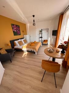 弗劳温普尔德Etoile aan Zee的一间卧室配有一张床、一张桌子和一张沙发