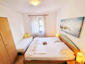 苏佩塔斯卡德拉加Apartment in Supetarska Draga with sea view, terrace, air conditioning, WiFi 4551-3的一间小卧室,配有床和窗户