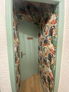 佩皮尼昂La Suite des Platanes的走廊上设有花卉壁纸的门