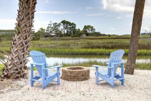 泰比岛El Rey Collection 1的两把蓝色椅子坐在火坑旁