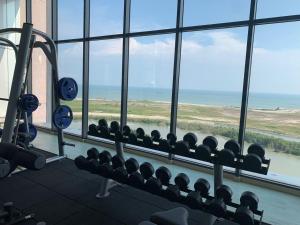马六甲lmperio Residence Melaka - Private Indoor Hot Jacuzzi的一间健身房,从窗户可欣赏到海景