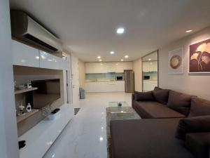 MakkasanCondominium Sukhumvit Soi 5 - BTS Nana- Room Size 47m2的一间带棕色沙发的客厅和一间厨房