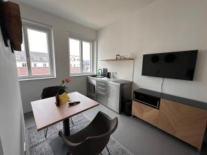 林茨Rilke Apartments的一间带桌子的客厅和一间厨房