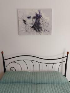 萨摩斯Ina House的一张床上墙上的女人画
