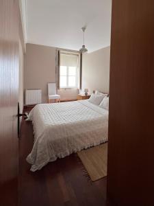 维亚纳堡Apartment Vedória的卧室配有白色的床和窗户