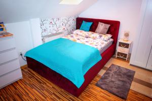 热舒夫Trend Apartment Old Market Rzeszów的一间小卧室,配有一张红色床头板的床