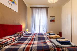 都灵Turin In Wine: appartamento incantevole a Torino.的一间卧室配有两张床和一张铺着地毯的卧室