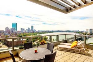 波士顿The Liberty, a Luxury Collection Hotel, Boston的市景阳台配有桌椅。