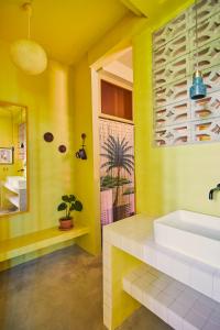 圣胡安MOOD HAUS by DW的黄色的浴室设有水槽和镜子