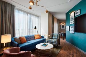 芝加哥芝加哥扎卡里翠贡精选酒店 的客厅配有蓝色的沙发和椅子