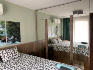 索非亚Niko's deluxe apartment的一间卧室配有两张床和镜子