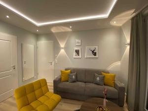 泰克伦堡DRIEHOF LifeStyle Comfort Apt 4的带沙发和黄色椅子的客厅