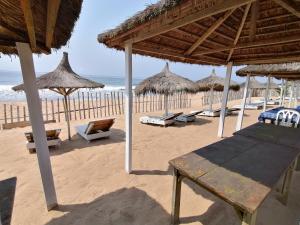 大巴萨姆Capriccio的海滩上设有遮阳伞和椅子,还有大海