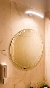 勒克瑙AASHIYANA HOMESTEAD DLF My Pad的浴室墙上的圆镜子