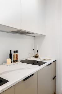 派尔努Bob W Pärnu的厨房配有白色橱柜和炉灶烤箱。