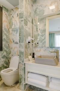 RizokarpasoBlue Sea Karpasia Hotel的一间带卫生间、水槽和镜子的浴室