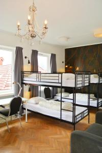 卑尔根City Hostel Bergen的客房设有三张双层床和吊灯。