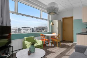 雷克雅未克Icelandic Apartments by Heimaleiga的客厅配有桌椅和窗户。