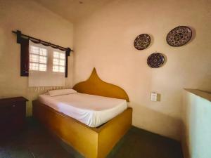 埃斯孔迪多港Hotel Rancho Escondito的卧室配有一张挂在墙上的带板子的床