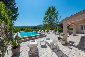 米利尼Luxury Vila Divina-Exceptional privacy的一个带椅子的庭院和一个游泳池