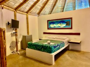 卡诺阿斯德蓬萨尔Waltako Beach Culture的卧室配有一张床