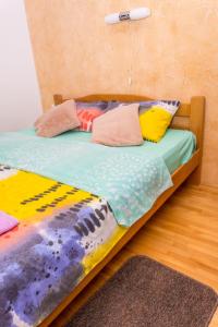 索科矿泉村Apartman SAN的一张床上有色彩缤纷的枕头