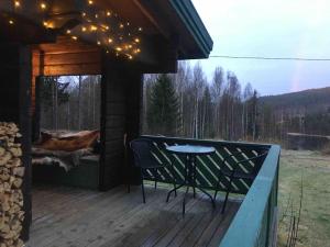 吕勒奥Log Cabin, forrest , sea view, north Sweden.的甲板上配有桌椅的门廊