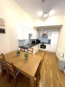 伦敦Camden Budget Suites - Next to Station and Camden Market的厨房配有木桌和椅子