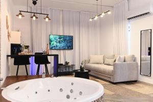 提比里亚YalaRent - Liri Resort的客厅设有大浴缸和沙发。