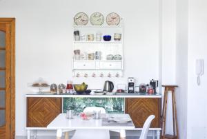 卡洛福泰Mencin的墙上的白色厨房配有桌子和盘子