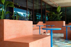 里斯本JAM Lisbon的两张蓝色桌子和一张长凳,位于大楼前