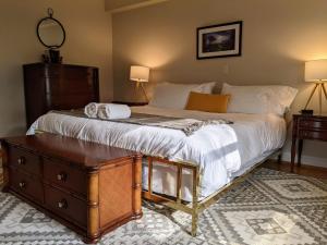 格林威治Stanton House Inn的一间卧室配有一张大床和木制梳妆台