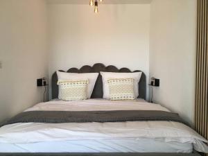 勒芬根Gemütliches Apartment mit wundervollem Weitblick的卧室配有一张带白色床单和枕头的大床。