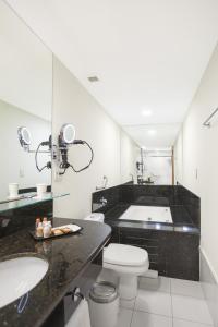 维多利亚维多利亚港金色郁金香酒店的浴室配有盥洗盆、卫生间和浴缸。