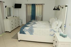 Cidade VelhaCidade Paradise Guesthouse的一间卧室配有一张带梳妆台和镜子的床
