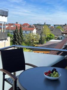 腓特烈港Ferienwohnung Bodenseeglück的阳台上的桌子上放着一碗水果
