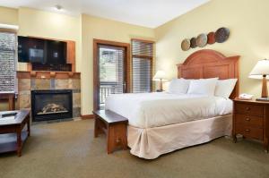 帕克城Sundial Lodge by Park City - Canyons Village的一间卧室设有一张大床和一个壁炉