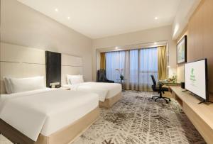 青浦上海虹桥西郊假日酒店的酒店客房设有两张床和一台平面电视。