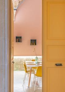 加拉蒂纳canUdis的一间带桌子和黄色椅子的用餐室
