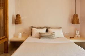 卡马利艾梅思酒店的一间卧室配有带白色床单和枕头的床。