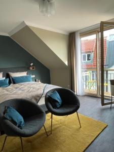 罗斯托克The Green Rostock Apartment Hotel的卧室在床前配有两把椅子