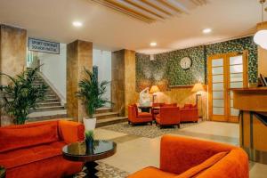 布拉格Metropolitan Old Town Hotel - Czech Leading Hotels的客厅配有橙色家具和楼梯