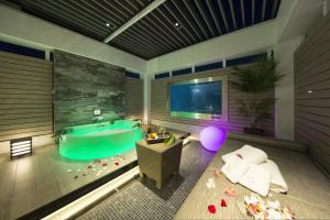 京都绿色情趣酒店（仅限成人）的带浴缸的浴室和带桌子的客房