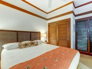 科洛阿Kiahuna Plantation Resort Kauai by OUTRIGGER的一间卧室设有一张大床和一个窗户。
