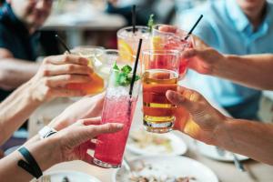普拉亚登博萨Thee Ibiza Suites - Ushuaia Beach的一群坐在桌子旁喝着饮料的人