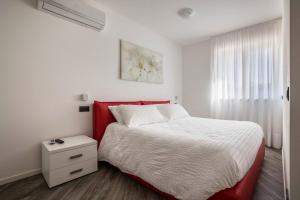 德罗Appartamenti Gaggiolo 1的卧室设有红色和白色的床和窗户。