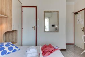 里米尼B&B Villa Madana的卧室配有一张床,墙上设有镜子