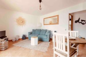 拉奥利瓦140 Oltre Majanicho by iRent Fuerteventura的客厅配有蓝色的沙发和桌子