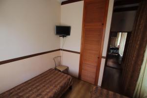 敖德萨乌宇提尼酒店的小房间设有床和电视